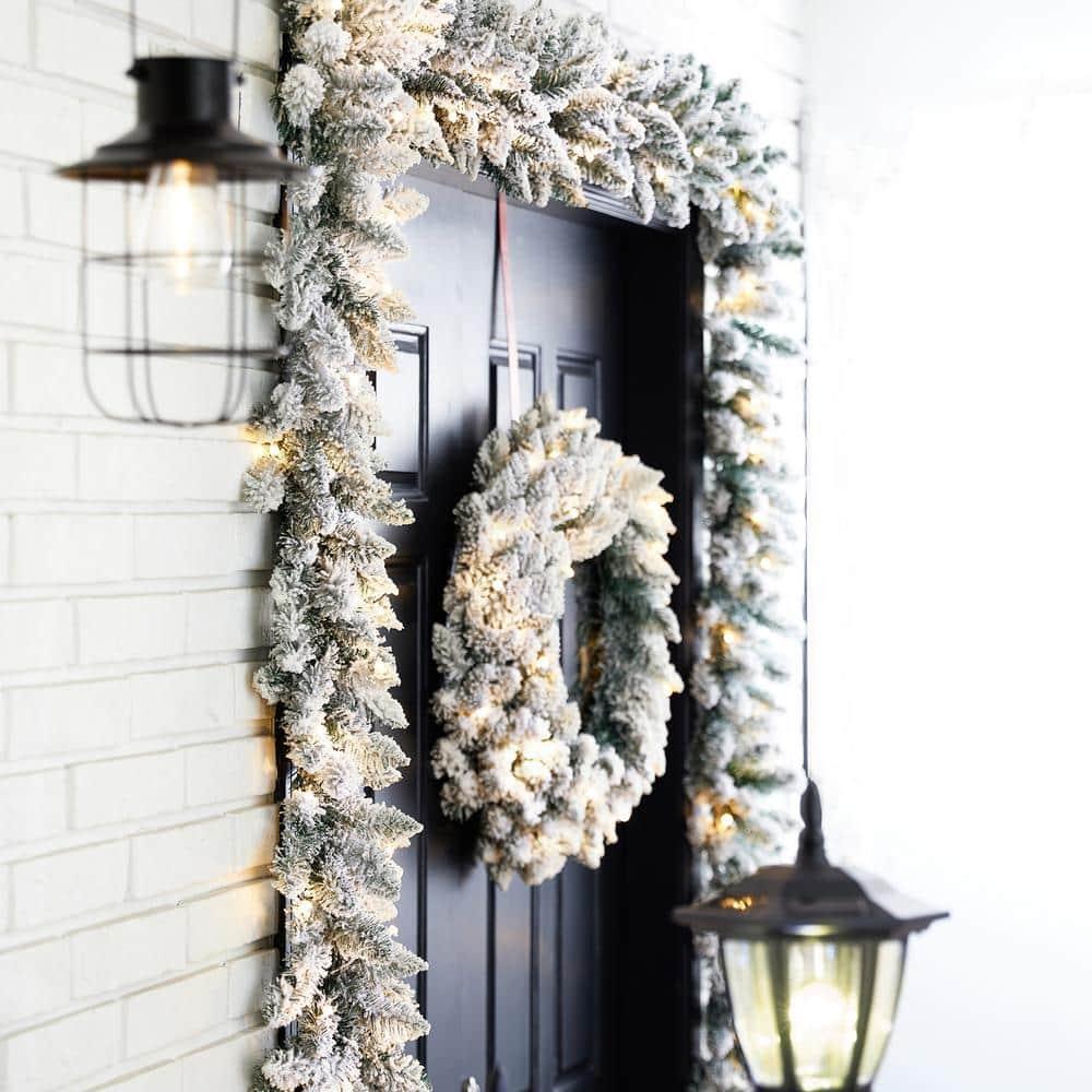 2-Pack 9 ft. Pre-lit LED Artificial Christmas Garland and 24 in. D Pre-lit Snow Flocked Christmas Wreath Set