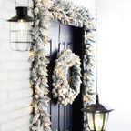 2-Pack 9 ft. Pre-lit LED Artificial Christmas Garland and 24 in. D Pre-lit Snow Flocked Christmas Wreath Set