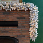 2-Pack 9 ft. Pre-lit LED Artificial Christmas Garland and 24 in. D Pre-Lit Snow Flocked Christmas Wreath Set
